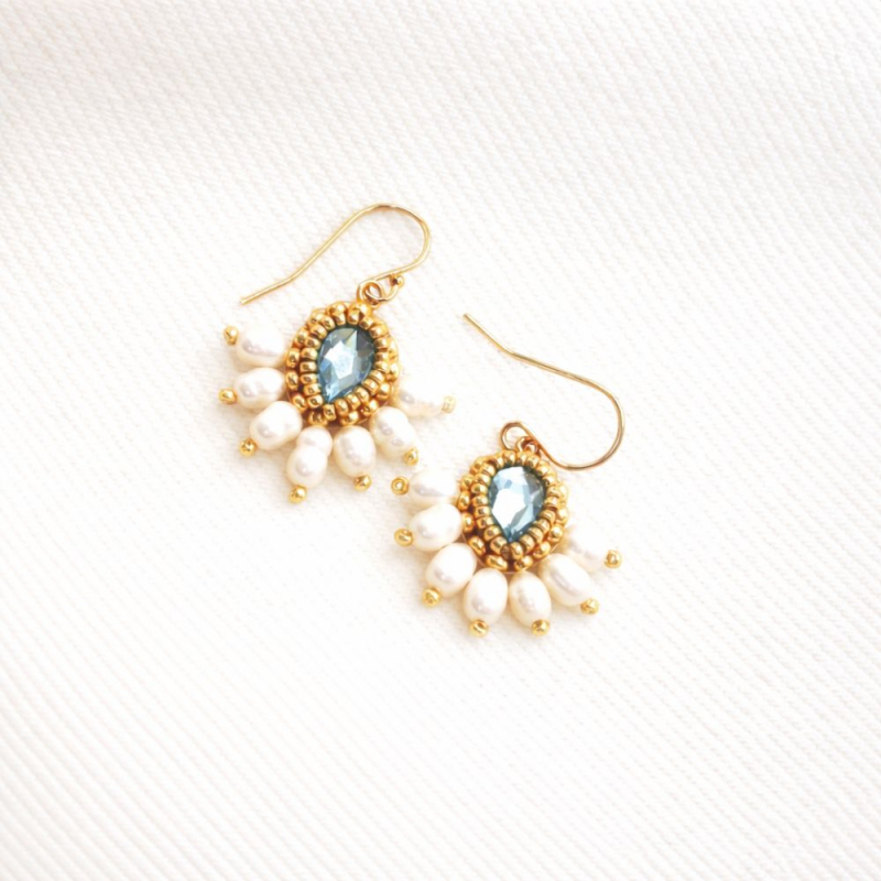 Avec un jean clair, un t-shirt blanc et une surchemise beige pour un look simple et lumineux.